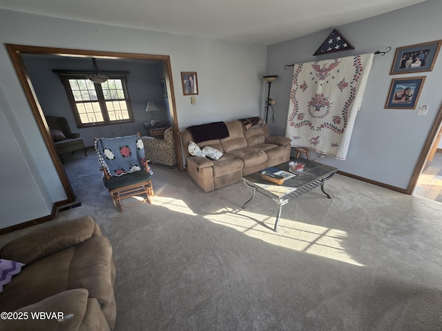 living area featuring baseboards and carpet floors