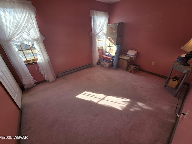 unfurnished bedroom with baseboard heating, carpet flooring, and baseboards