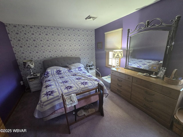 bedroom featuring visible vents, wallpapered walls, and carpet