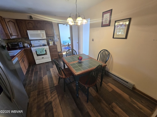 dining room featuring a toaster, baseboard heating, dark wood-type flooring, and an inviting chandelier