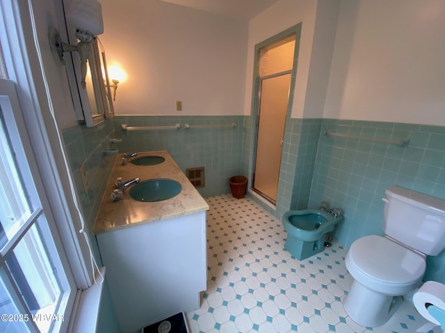 bathroom with tile walls, visible vents, a sink, and a stall shower