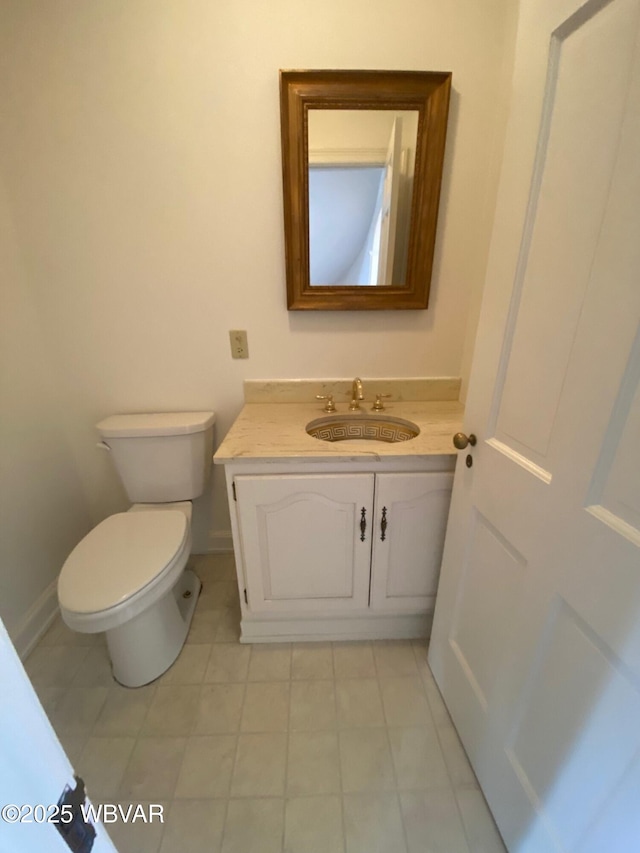 half bathroom with toilet, baseboards, and vanity