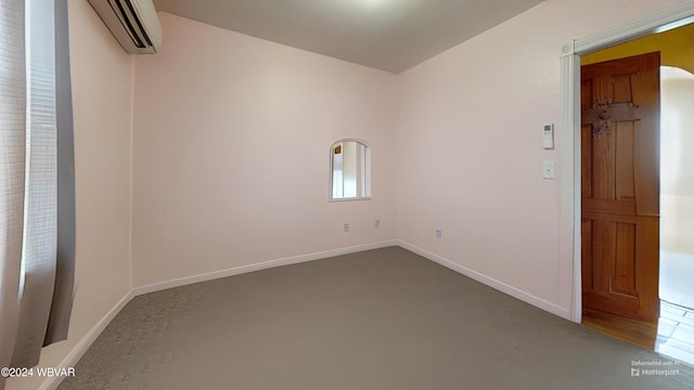 empty room with carpet flooring and a wall mounted AC