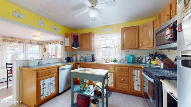 kitchen with backsplash, stainless steel appliances, plenty of natural light, and sink