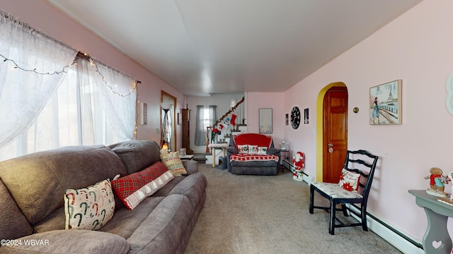 carpeted living room featuring a baseboard heating unit