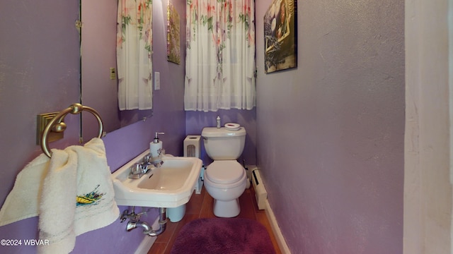 bathroom featuring sink, tile patterned flooring, a baseboard radiator, and toilet