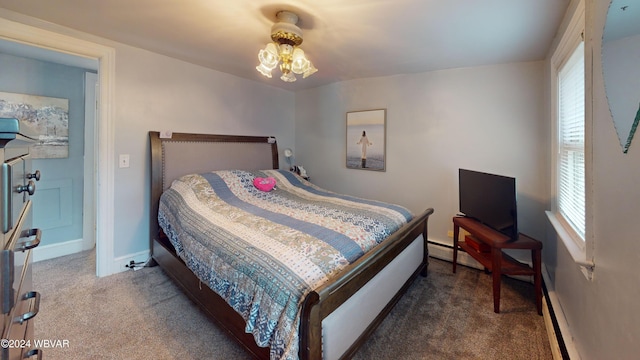 bedroom with dark carpet, baseboard heating, and a notable chandelier