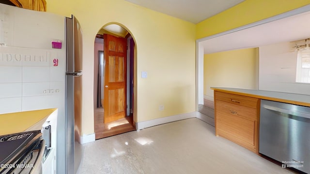 kitchen with stainless steel dishwasher and range with electric stovetop