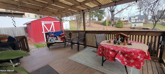 wooden terrace featuring a storage unit