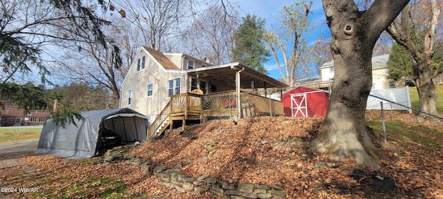 back of property featuring a storage unit