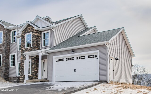 view of front of home featuring a front yard and a garage