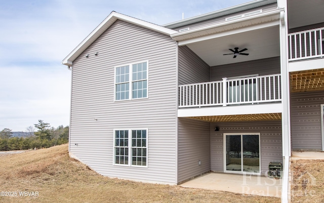 view of side of property with a shingled roof and a yard