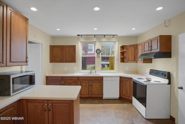 330 High St, Williamsport, PA 17701 - kitchen with white appliances, under cabinet range hood, a sink, brown cabinetry, and recessed lighting