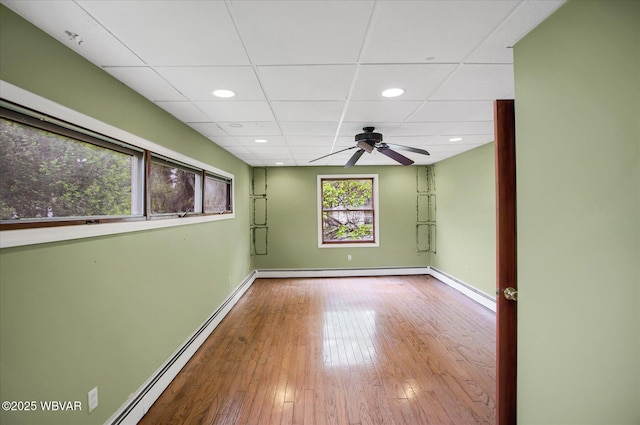 330 High St, Williamsport, PA 17701 - unfurnished room with a baseboard radiator, ceiling fan, a drop ceiling, wood-type flooring, and baseboards