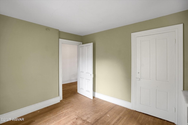 330 High St, Williamsport, PA 17701 - unfurnished bedroom with baseboards and wood finished floors