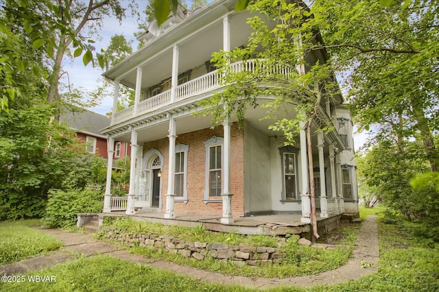 330 High St, Williamsport, PA 17701 - view of front of house with covered porch, brick siding, and a balcony