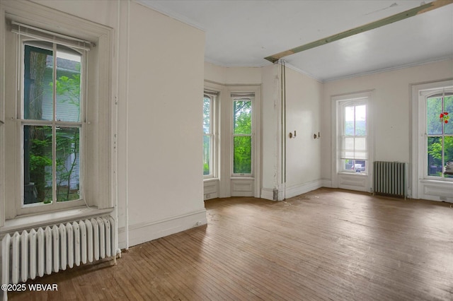 330 High St, Williamsport, PA 17701 - empty room with radiator heating unit, crown molding, wood-type flooring, and baseboards