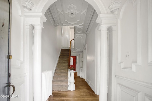 330 High St, Williamsport, PA 17701 - staircase featuring wood finished floors, ornate columns, a high ceiling, and arched walkways