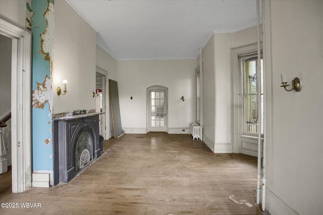 330 High St, Williamsport, PA 17701 - corridor featuring crown molding, wood finished floors, radiator heating unit, and arched walkways