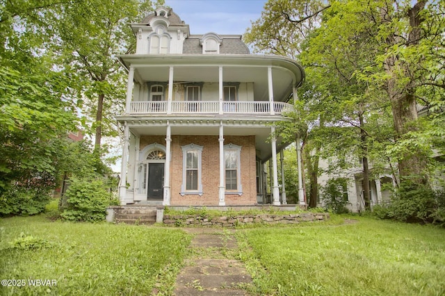 330 High St, Williamsport, PA 17701 - second empire-style home featuring a balcony, brick siding, a front yard, and mansard roof