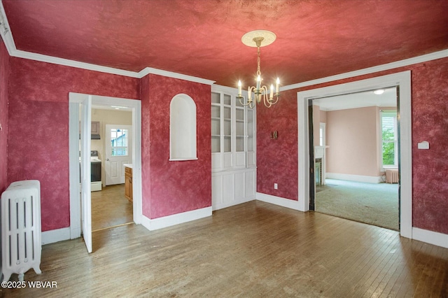 330 High St, Williamsport, PA 17701 - unfurnished dining area with radiator heating unit, hardwood / wood-style flooring, a chandelier, ornamental molding, and baseboards