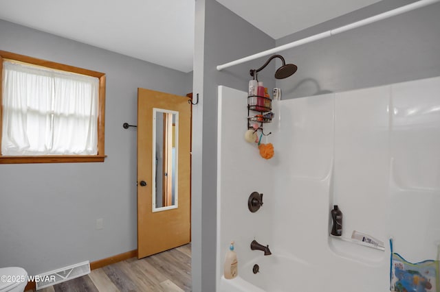 262 Walnut Ln, Jersey Shore, PA 17740 - bathroom featuring shower / bathtub combination, wood finished floors, toilet, and baseboards
