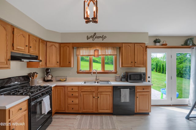 262 Walnut Ln, Jersey Shore, PA 17740 - kitchen with black appliances, under cabinet range hood, a sink, and plenty of natural light