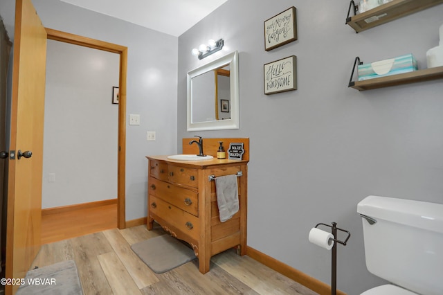262 Walnut Ln, Jersey Shore, PA 17740 - bathroom featuring wood finished floors, toilet, vanity, and baseboards