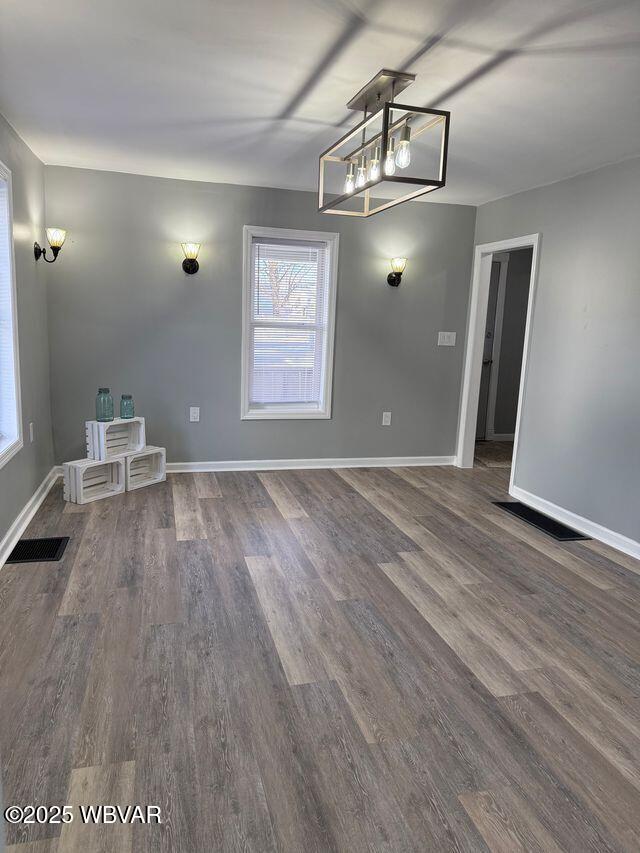 unfurnished dining area with dark hardwood / wood-style flooring