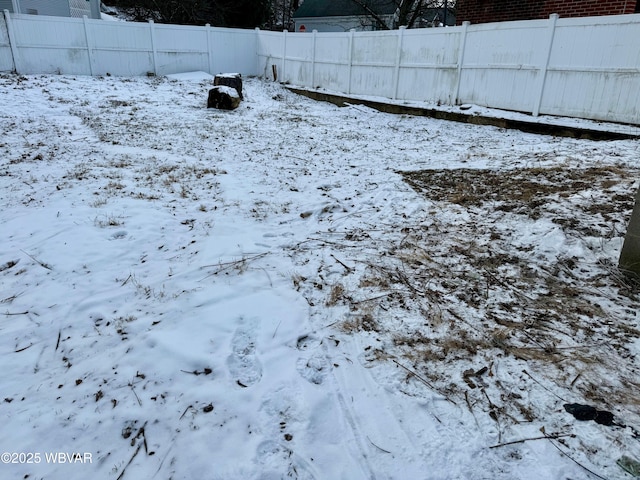 view of yard layered in snow