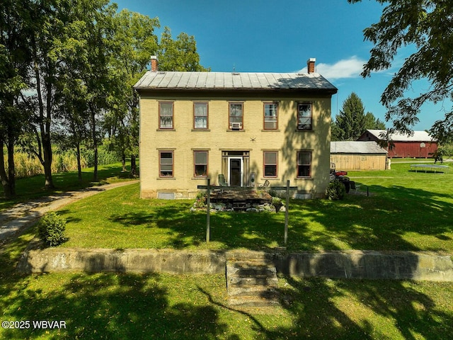 back of house with a lawn