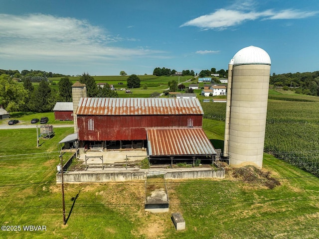 surrounding community featuring an outdoor structure and a rural view