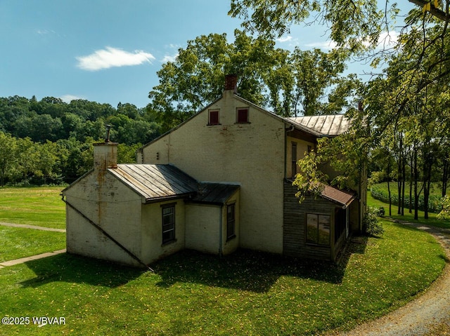 view of side of home featuring a lawn