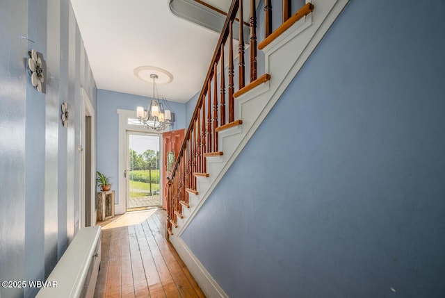 interior space with hardwood / wood-style flooring and a chandelier