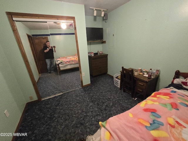 bedroom with dark carpet and a closet