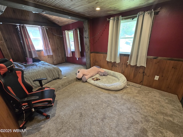 carpeted bedroom with wood walls, a wainscoted wall, and wood ceiling