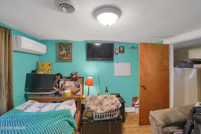522 S Main St, Jersey Shore, PA 17740 - bedroom with a wall mounted air conditioner, visible vents, and wood finished floors