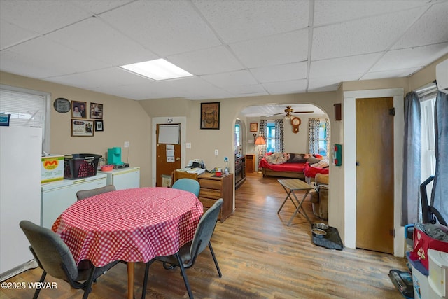 522 S Main St, Jersey Shore, PA 17740 - dining room featuring arched walkways, a wealth of natural light, light wood-style floors, and a drop ceiling