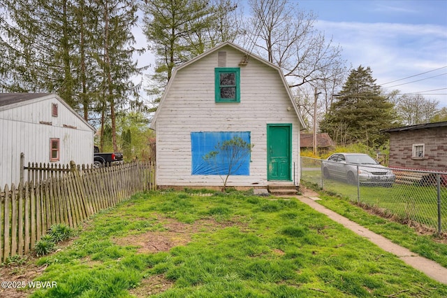 522 S Main St, Jersey Shore, PA 17740 - back of property with a lawn, a gambrel roof, entry steps, and fence