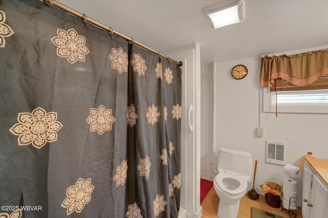 522 S Main St, Jersey Shore, PA 17740 - bathroom with heating unit, toilet, a shower with curtain, and vanity