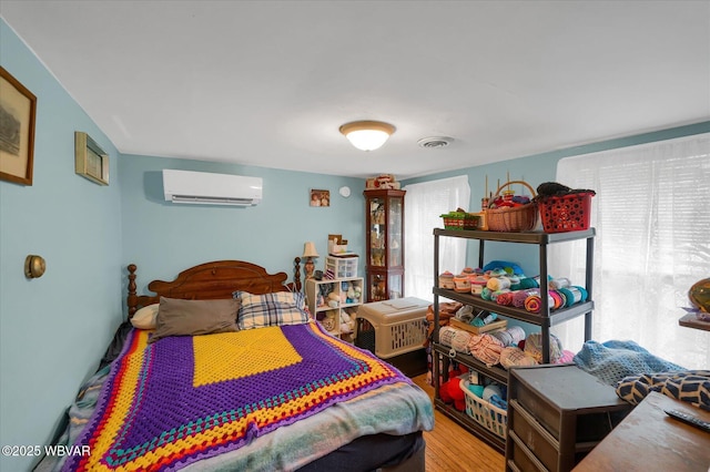 522 S Main St, Jersey Shore, PA 17740 - bedroom with visible vents, a wall mounted air conditioner, and wood finished floors