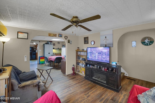 522 S Main St, Jersey Shore, PA 17740 - living area featuring arched walkways, ceiling fan, an ornate ceiling, and wood finished floors