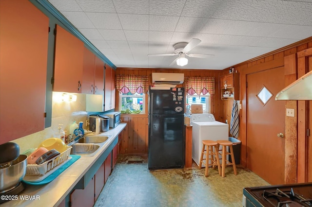 522 S Main St, Jersey Shore, PA 17740 - kitchen with stainless steel microwave, a sink, freestanding refrigerator, an AC wall unit, and washer / dryer