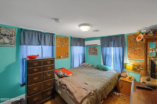 522 S Main St, Jersey Shore, PA 17740 - bedroom with a wall mounted air conditioner and wood finished floors