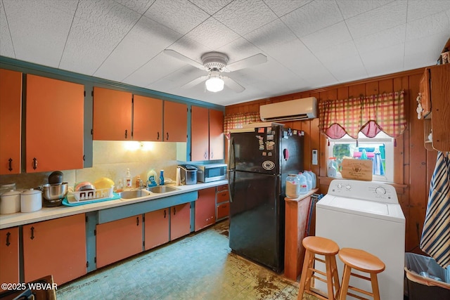 522 S Main St, Jersey Shore, PA 17740 - kitchen featuring stainless steel microwave, washer / clothes dryer, a sink, freestanding refrigerator, and a wall mounted AC