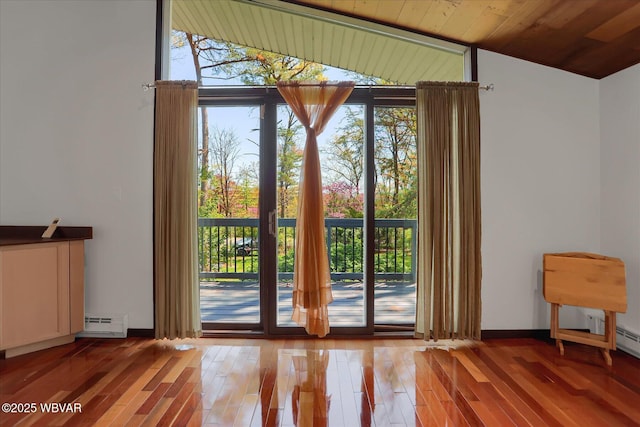 entryway featuring wood ceiling, baseboard heating, vaulted ceiling, and light wood-type flooring