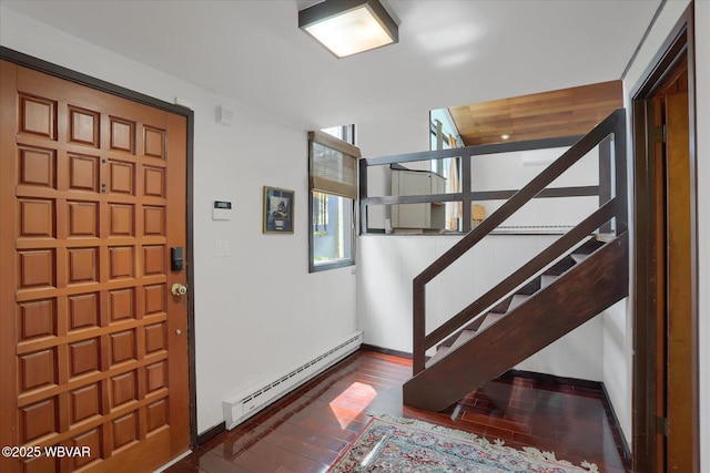 entryway featuring stairway, baseboards, a baseboard radiator, and hardwood / wood-style floors