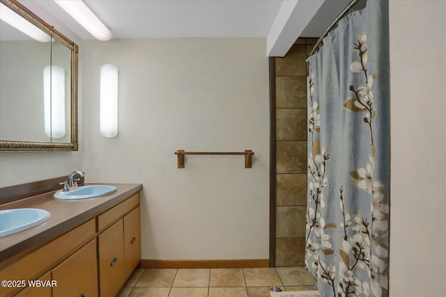 full bath with double vanity, tile patterned floors, curtained shower, and a sink