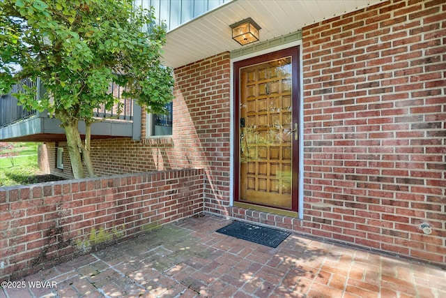 doorway to property with brick siding