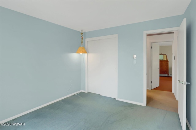 carpeted empty room with baseboards